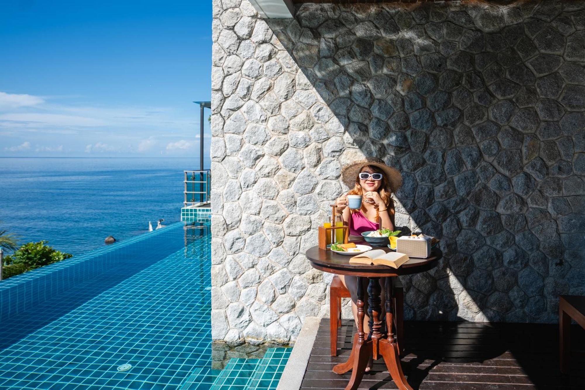 Zenmaya Oceanfront Phuket, Trademark Collection By Wyndham Patong Екстериор снимка A woman enjoying a morning coffee at the poolside of the resort
